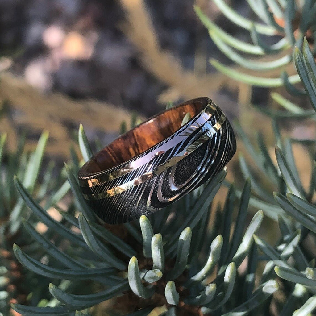 8mm Damascus Steel Ring with Dual 14k Yellow Gold & Rose Gold Off Center Grooves and a Arizona Ironwood Sleeve